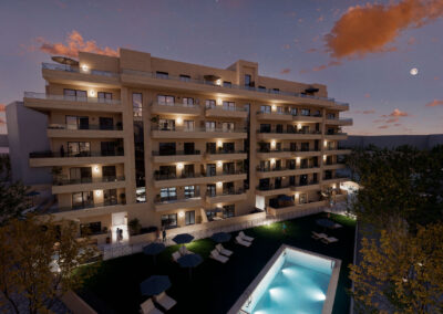 Vista exterior nocturna de La Alfonsica II con piscina iluminada